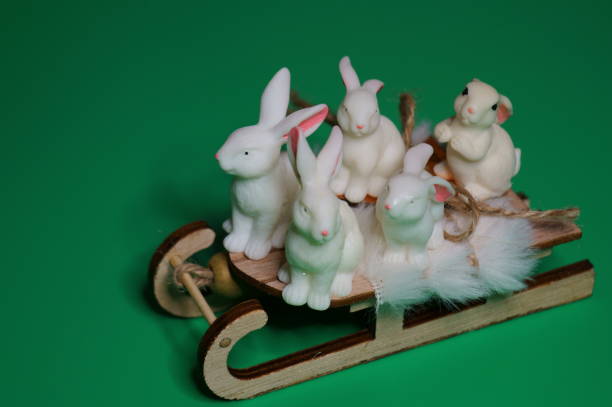 A group of rabbits on a toy sleigh. Christmas decorations.