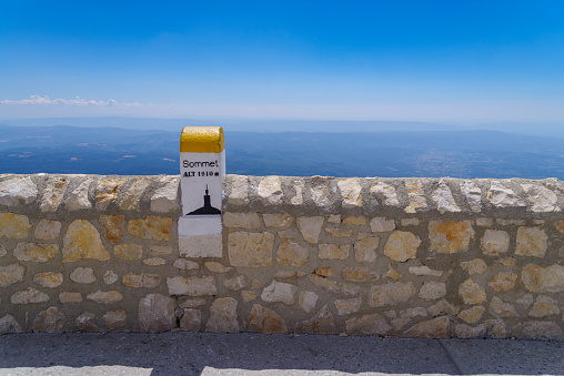 marker stone on top of the Mont Ventoux, France. At 1,909 m (6,263 ft), it is the highest mountain in the region and has been nicknamed the Beast of Provence.