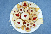 Various shapes of Linzer cookies filled with strawberry jam