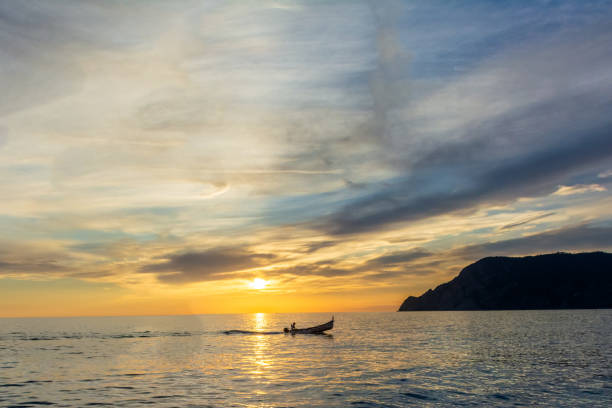 istock Fisherman goes home at sunset 1443820111