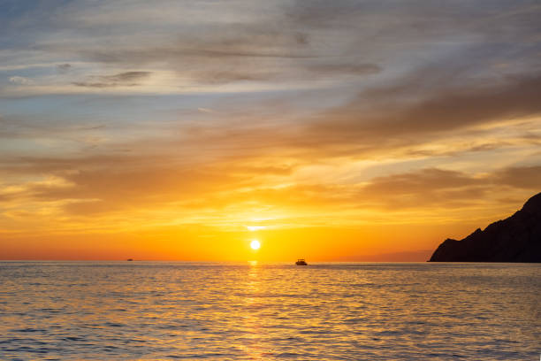 istock Fisherman goes home at sunset 1443820144