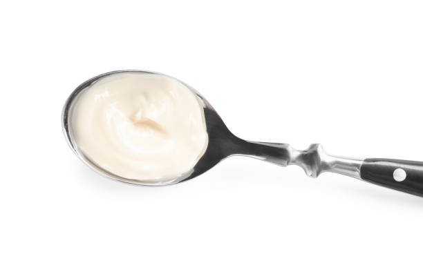 istock Spoon with tasty mayonnaise isolated on white, top view 1443822999