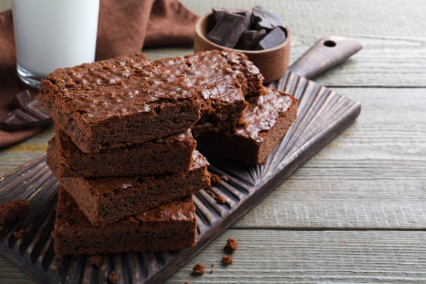 istock Delicious chocolate brownies on wooden table. Space for text 1443823774