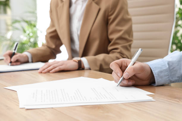 istock Man signing contract at table in office, closeup. 1443823881