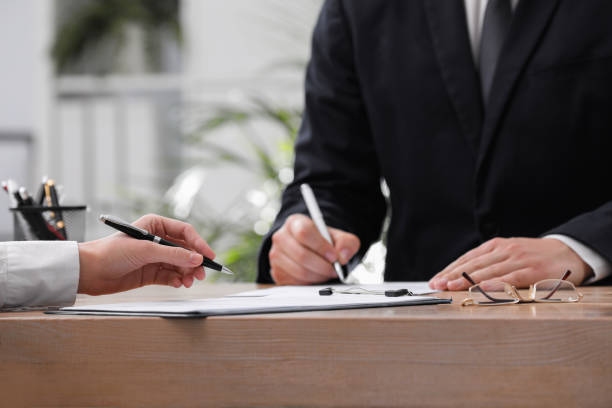 istock Woman reading document at table in office, closeup. Signing contract 1443823900