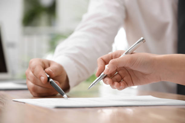 istock Businesspeople signing contract at table in office, closeup 1443823920