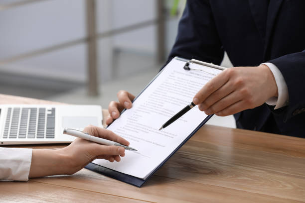 istock Businesspeople signing contract at table in office, closeup 1443823925