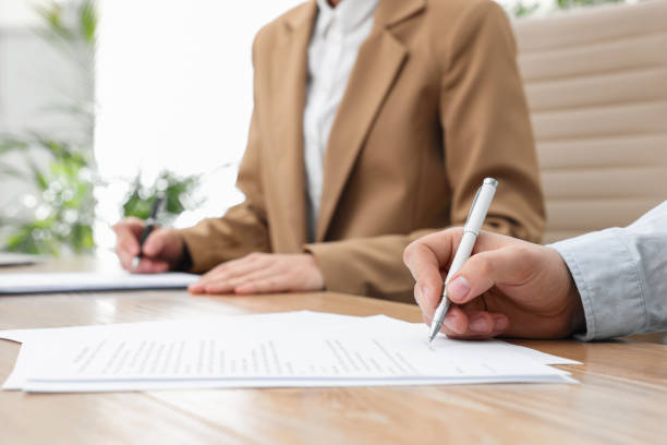istock Man signing contract at table in office, closeup. 1443823953