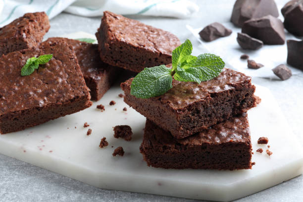 istock Delicious chocolate brownies with fresh mint on grey table 1443824340