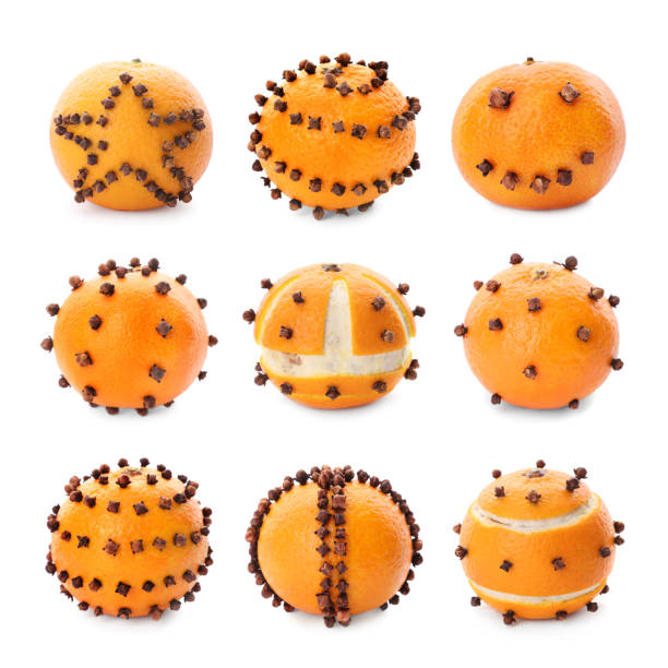 Set with pomander balls made of tangerine and cloves on white background Set with pomander balls made of tangerine and cloves on white background scent container stock pictures, royalty-free photos & images