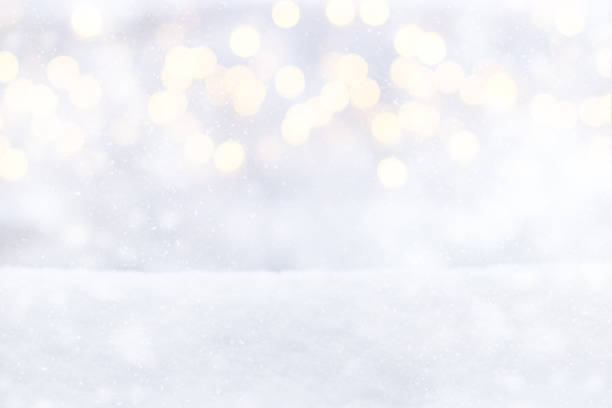 istock Blurred Christmas lights on a snowy background. Winter background, white snow, glitter defocused lights, bokeh, Snowflakes and snowfall 1443824598