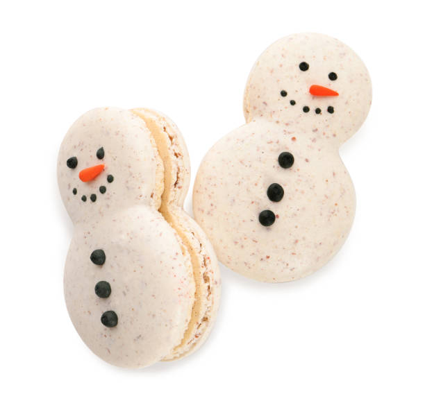 istock Beautifully decorated Christmas macarons on white background, top view 1443824810