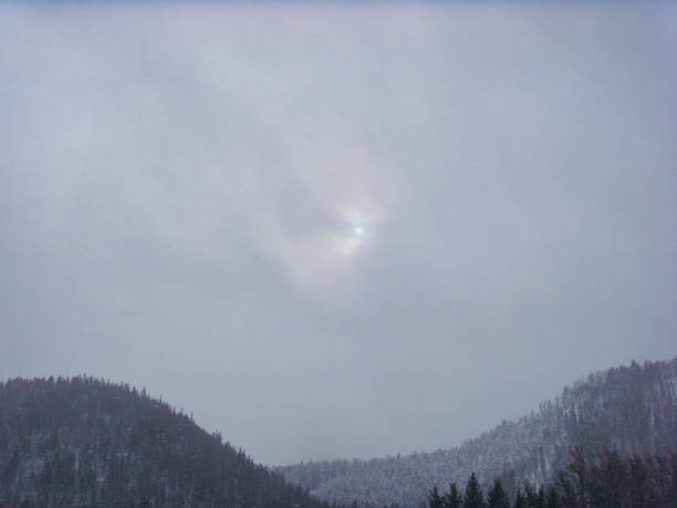 Photo of Gray cloud obscures sun over the mountains