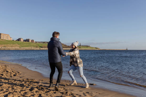 istock Playful Couple by the Sea 1443826535