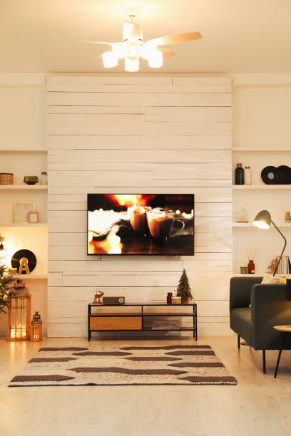 плазменный телевизор на белой деревянной стене в гостиной красиво украшен к рождеству - apartment design domestic room television стоковые фото и изображения