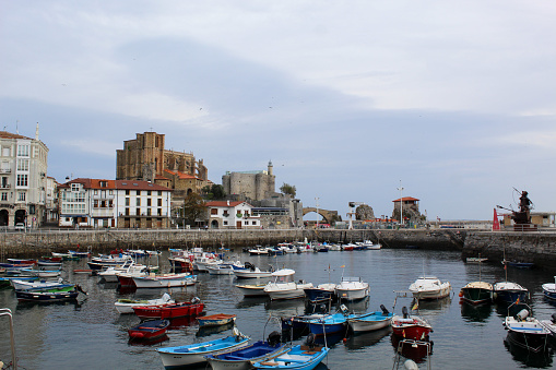 Castro Urdiales, Spain  – October 29, 2022: Old Port  of the historical town of Castro Urdiales with fishing boats.