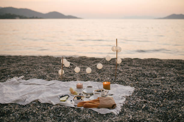 istock Romantic picnic by the sea at sunset. 1443833170