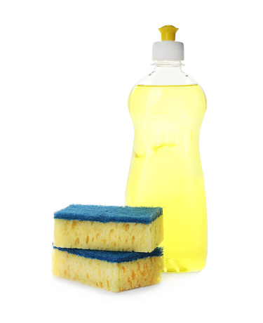 Bottle of detergent and cleaning sponges on white background