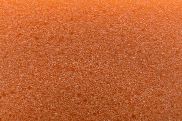 istock Orange cleaning sponge as background, top view 1443833390