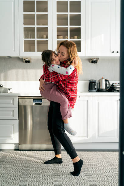 istock Cute girl feels great dancing with her mom in the kitchen 1443833496