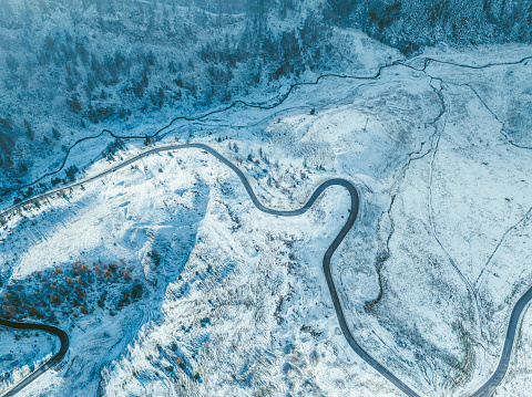 Scenic aerial view of winding road through Dolomites in winter