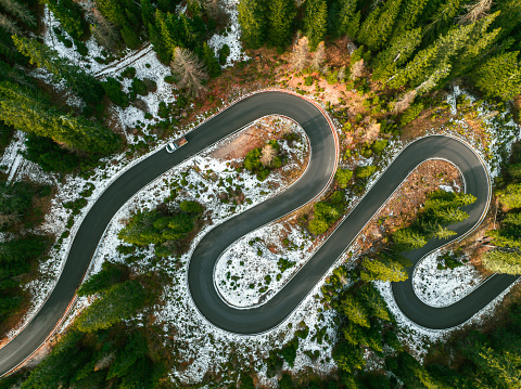 Aerial view of scenic winding road through Dolomites mountains