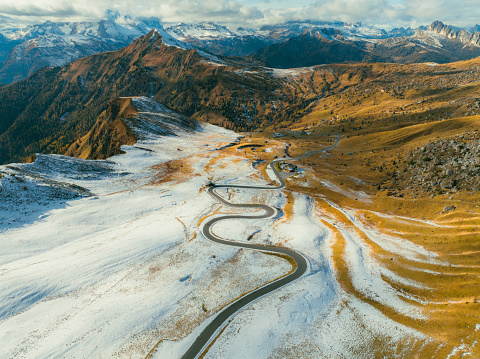 Scenic aerial view of winding road through Dolomites in winter