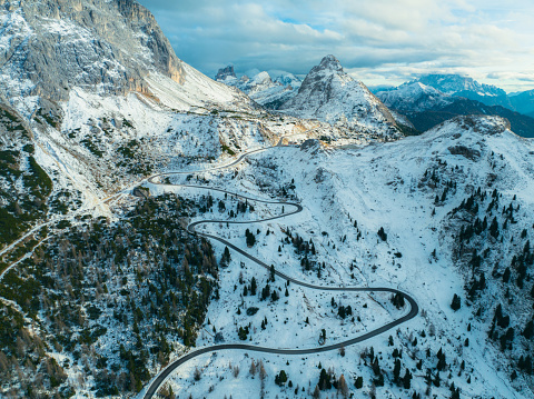 Scenic aerial view of winding road through Dolomites in winter