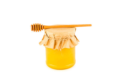 Honey pot and dipper isolated on white background as package design element.