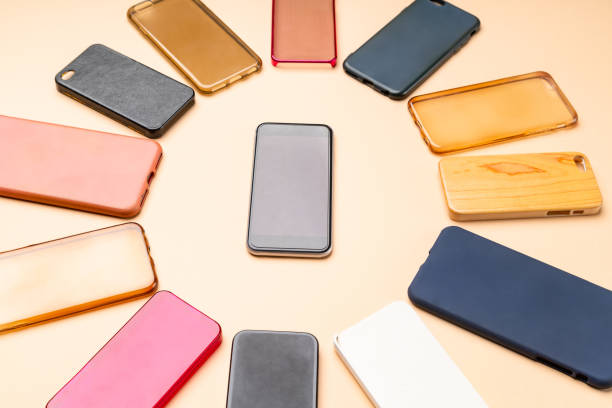 istock Choice of multicolored plastic back covers for mobile phones on neutral background with a smart phone on the side 1443842223