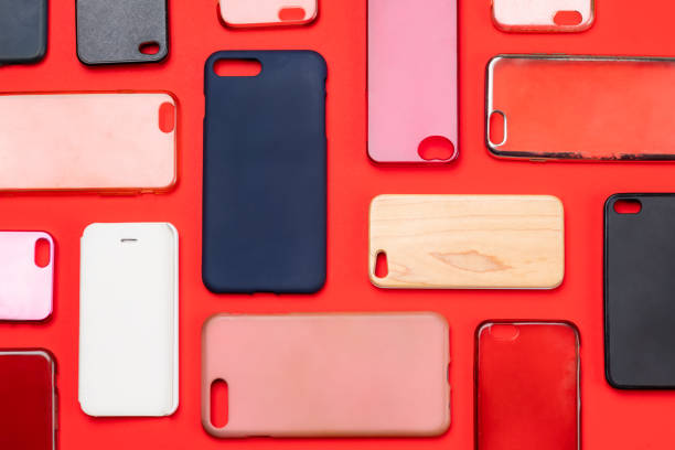 istock Pile of multicolored plastic back covers for mobile phone. Choice of smart phone protector accessories on red background. A lot of silicone phone backs or skins next to each other 1443842224