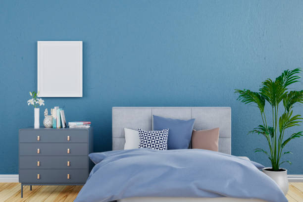 istock 3d rendered illustration of a blue wall bedroom with white mock up picture frame. 1443845710