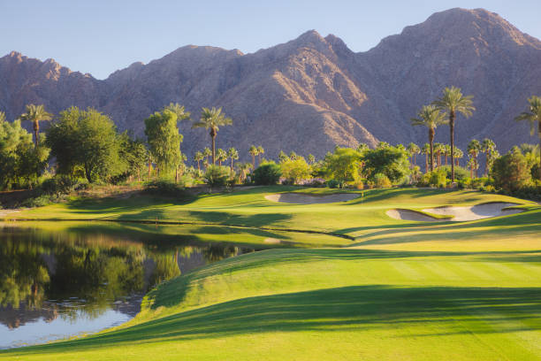 A beautiful golf course in the mountains. Idaho, United States. Golf resort in the pacific northwest. Beautiful landscaping and turf grass maintenance on this course. Dramatic summer sky with bentgrass greens and fairways. Nobody in the image. Golf course scenic. 