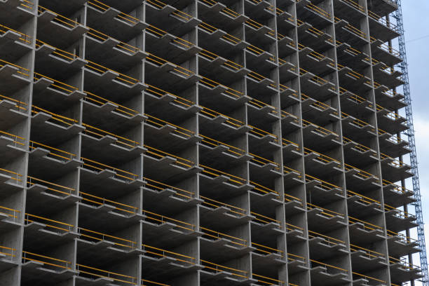 Monolithic concrete frame of new building. Construction of monolithic multi-storey house.