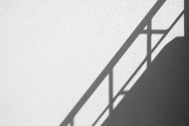 Banister Shadow on White Concrete Wall Texture Background in Minimal Concept.
