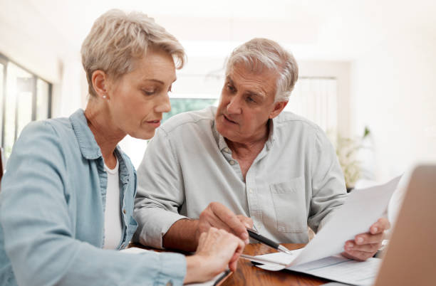 istock Finance, retirement and a couple online with budget or strategy plan with documents. Laptop, internet and savings, senior woman and man planning funds, mortgage or investment for retired lifestyle. 1443852709