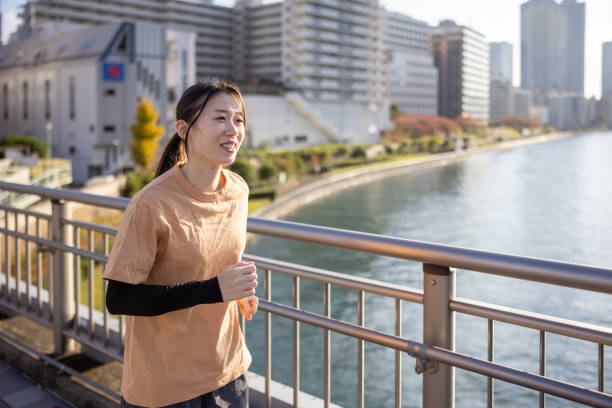 istock Female athlete running in bay area 1443854474