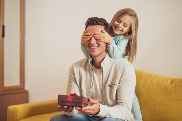 istock Daughter giving  gift to her father 1443854554
