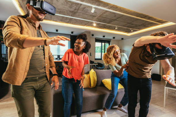 istock Happy friends having fun with VR in home interior 1443854709