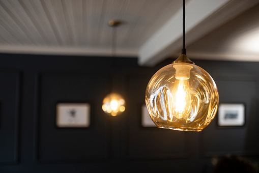 A close-up shot of a hanging light in a restaurant.