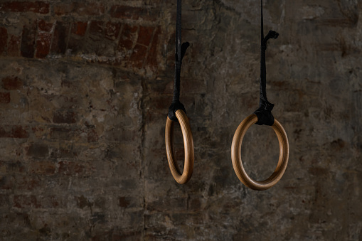 gymnastic rings and bars on the background of an old brick wall