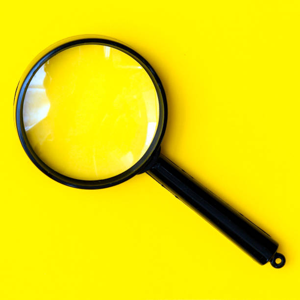 istock Black magnifier on a yellow  background. 1443861645