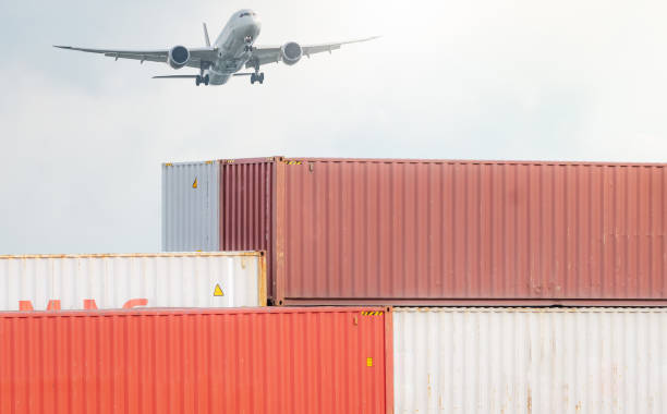 istock Air logistics. Cargo airplane flying above stack of logistic container. Cargo and shipping business. Container ship for export logistic. Logistic industry from port to port. Freight transportation. 1443862349