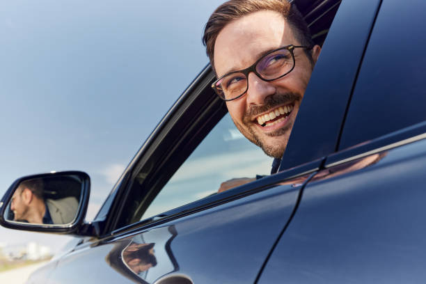 istock Happy man parking his car in reverse. 1443864074