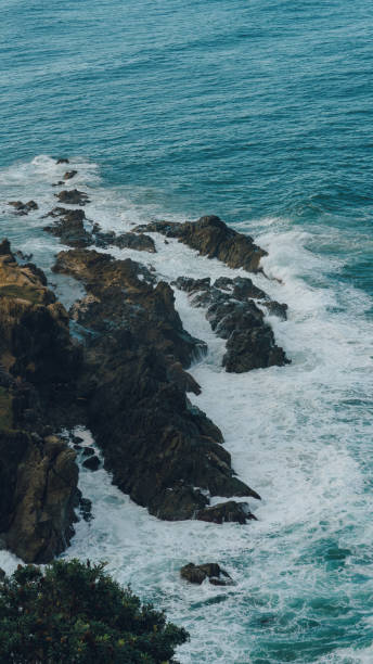 Seascape waves smashing rocks aerial view stock photo