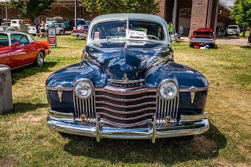 Des Moines, IA - July 03, 2022: High perspective front view of a 1941 Oldsmobile Series 60 Club Coupe at a local car show.