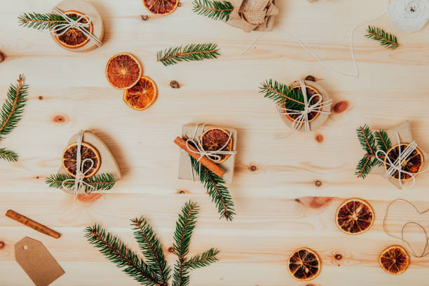 istock Eco-friendly Christmas gift packaging, zero-waste, no plastic holidays. Craft cardboard gift boxes decorated with spruce and dried orange. Handmade presents. Flat lay, Top view, selective focus. 1443868382