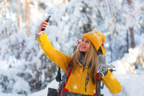 Photo of a blond caucasian woman during outdoor hiking in winter forest. stock photo
