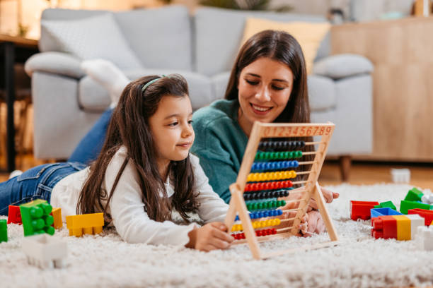 istock Young Mother And Daughter Playing With Abacus On The Carpet 1443875080