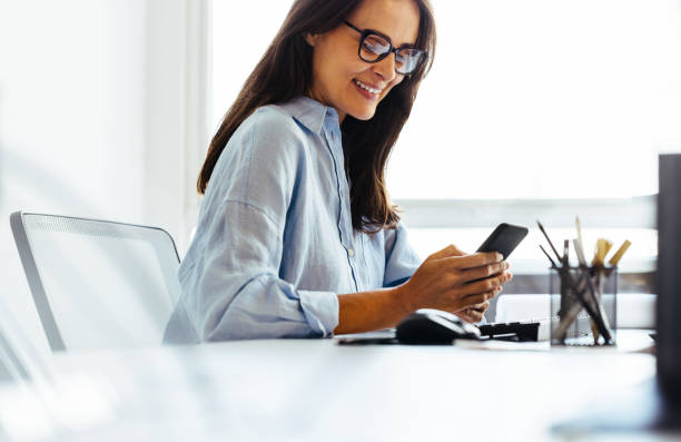 istock Design professional reading a text message on her phone in an office 1443876114
